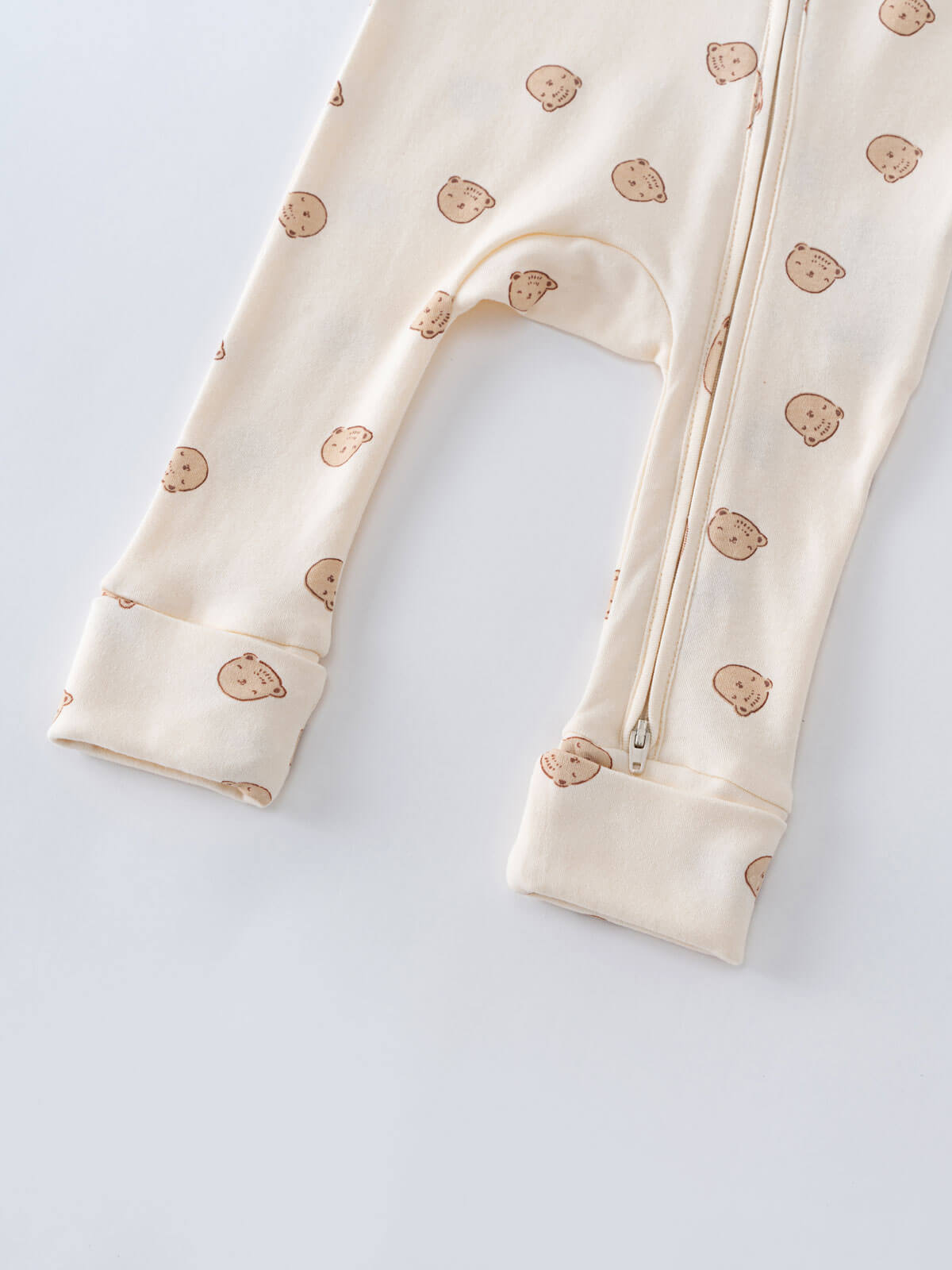 Close-up of cream fabric with brown bear print and zipper detail Printed Long Sleeve One Piece - Cosy Bear Ecru Baby boy