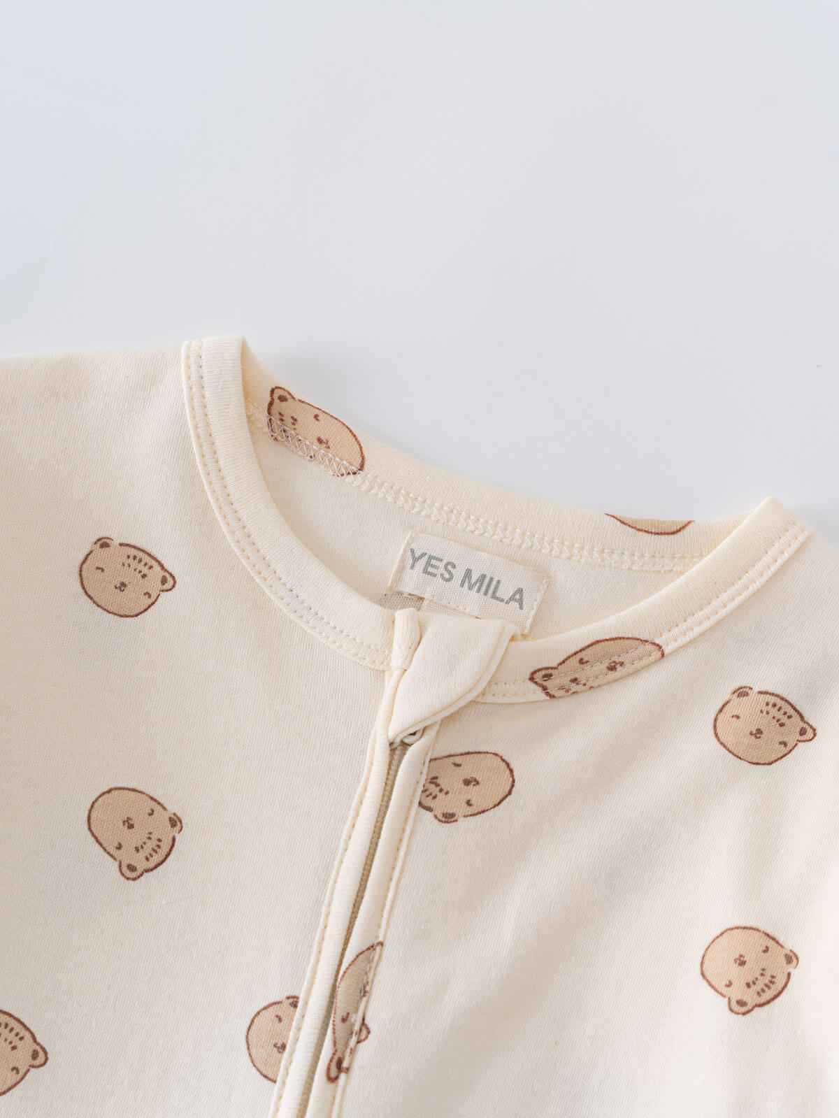 Close-up of cream baby onesie with brown bear print and zipper Printed Long Sleeve One Piece - Cosy Bear Ecru Baby boy