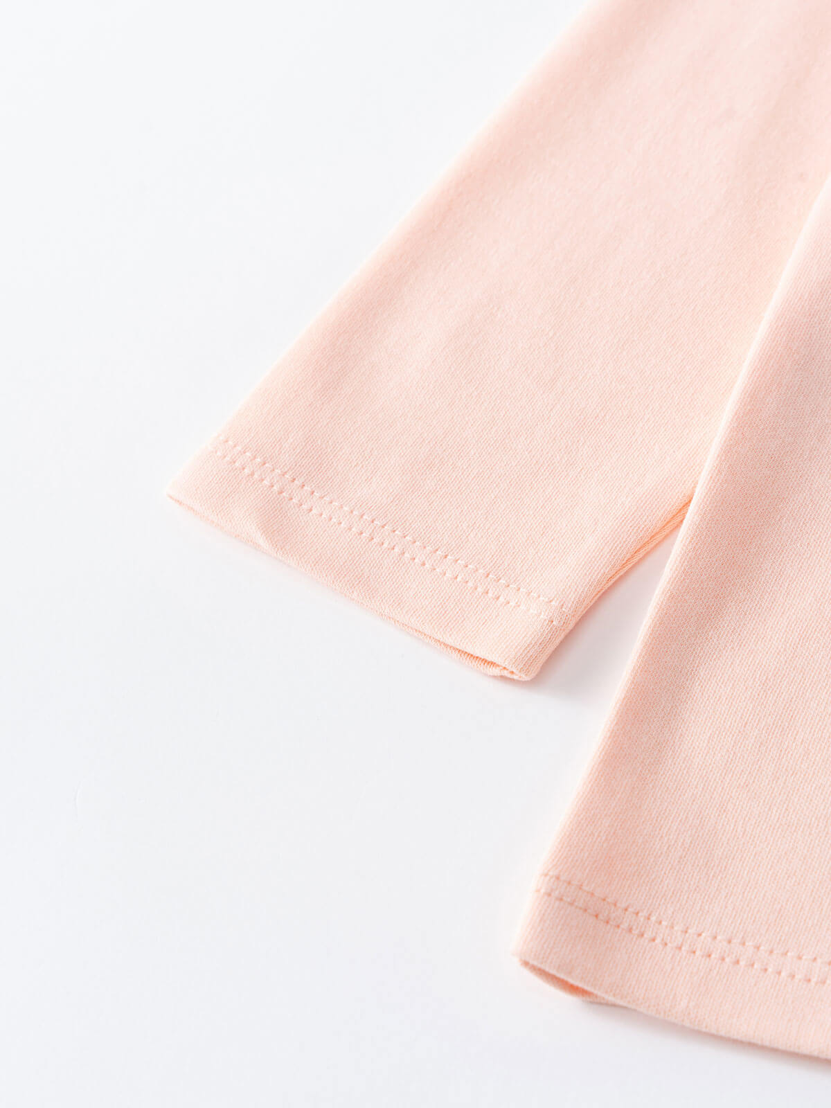 Close-up of pale pink long sleeve shirt cuffs with hemstitched detail Printed Long Sleeve Tee - Dove Girls