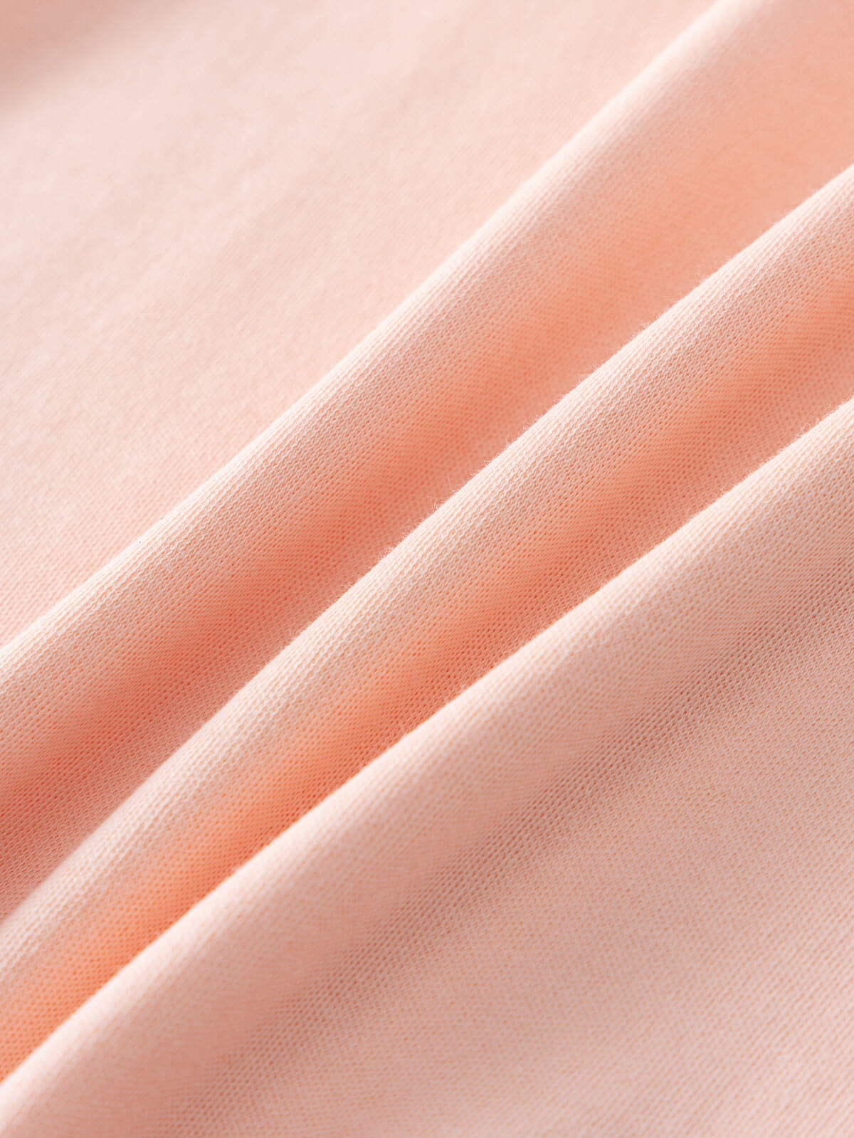 Close-up of soft peach fabric with diagonal folds and visible texture Printed Long Sleeve Tee - Dove Girls