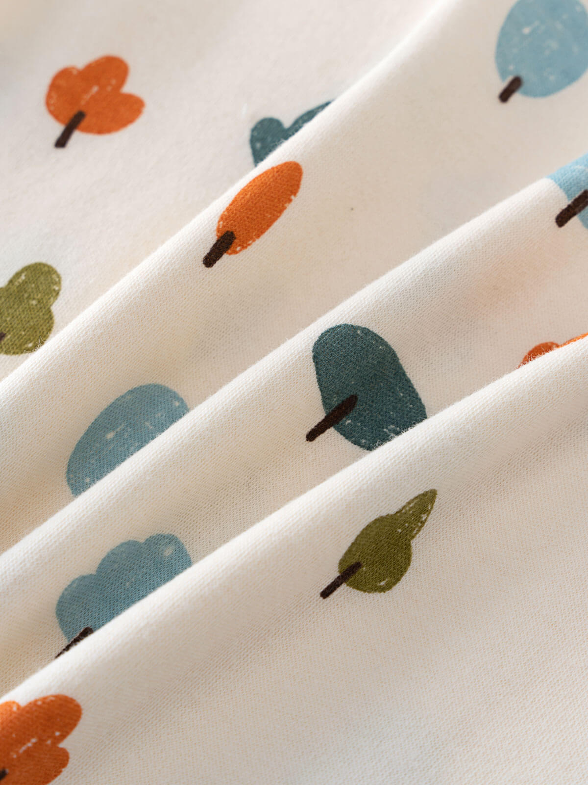 White fabric with small printed trees in orange, blue, and green colors Printed Short Sleeve Tee - Forest Adventure Ecru Boys