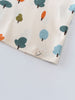 Close-up of cream fabric with colorful tree prints and smiley face label Printed Short Sleeve Tee - Forest Adventure Ecru Boys