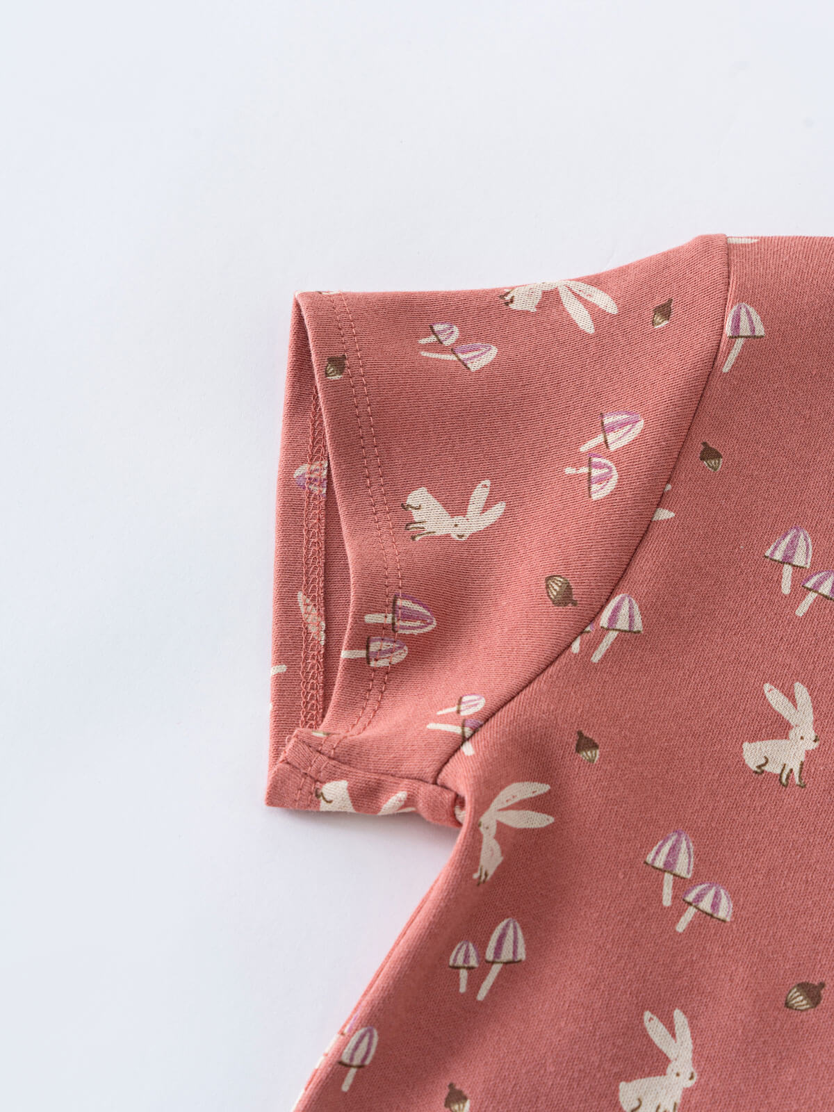 Close-up of coral fabric with bunny and mushroom print pattern Printed Short Sleeve Tee - Forest Gathering Rosehip Girls