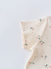 Close-up of cream fabric with small pink flowers and green leaves Printed Short Sleeve Tee - Wild Meadow Ecru Girls