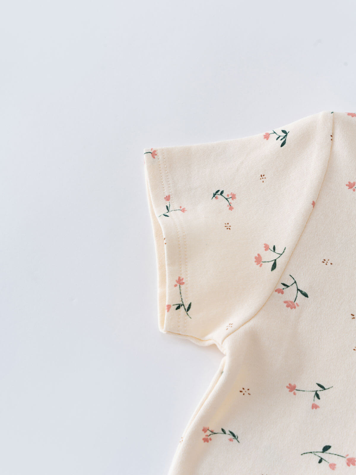 Close-up of cream fabric with small pink flowers and green leaves Printed Short Sleeve Tee - Wild Meadow Ecru Girls