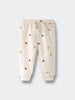 Cream-colored sweatpants with small acorn face print pattern throughout Printed Sweatpants - Little Acorn Ecru Baby girl
