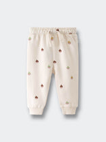 Cream-colored sweatpants with small acorn face print pattern throughout Printed Sweatpants - Little Acorn Ecru Baby girl