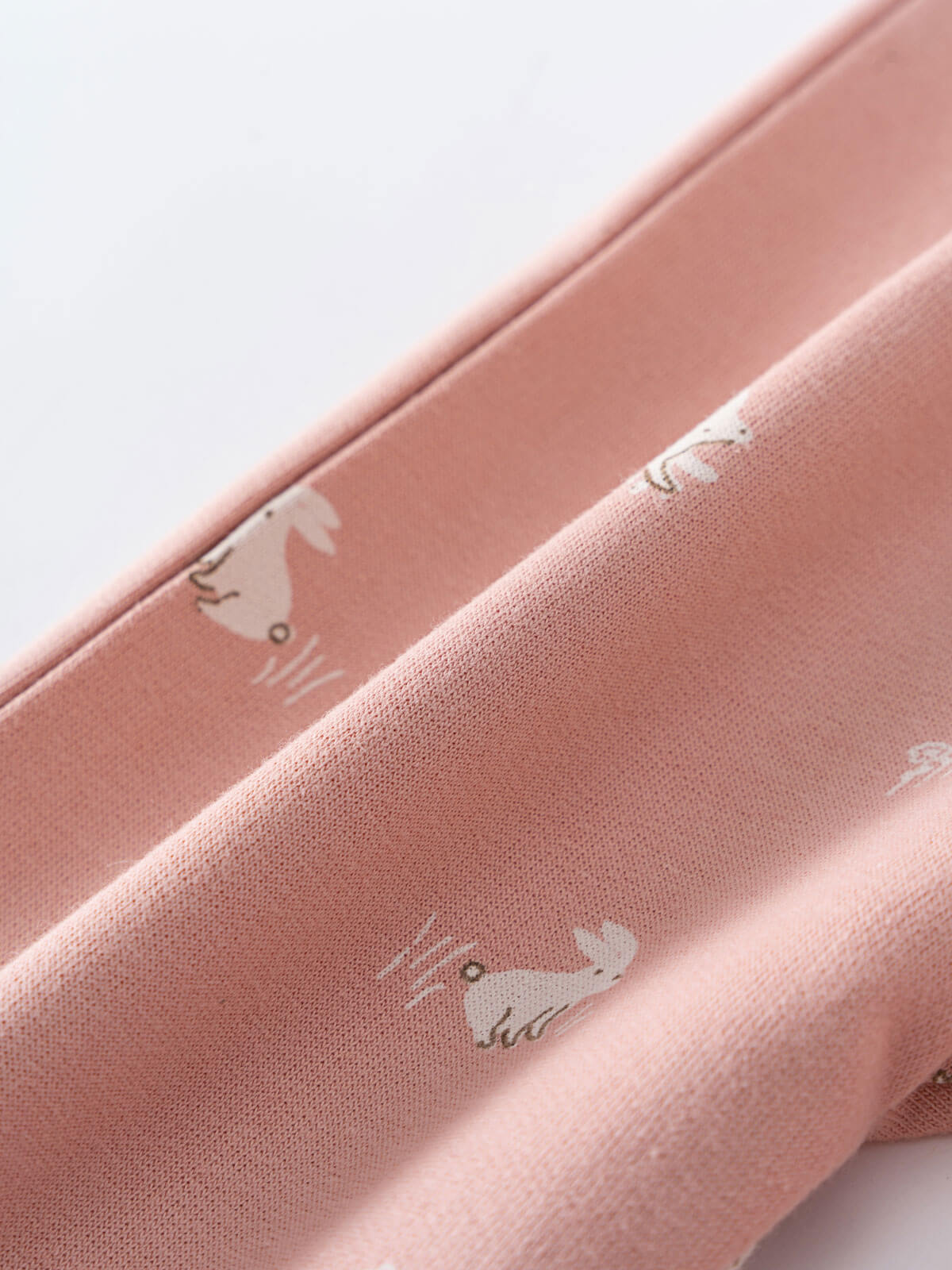 Close-up of pink fabric with small white bunny rabbit print pattern Printed Sweatpants - Meadow Friends Blush Baby girl