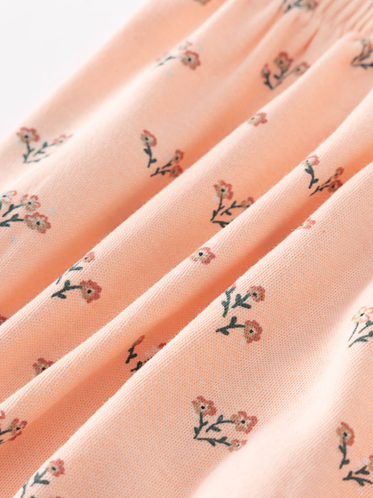 Close-up of peach fabric with small floral print pattern Printed Bloomers - Wildflower Bouquet Pink Baby girl