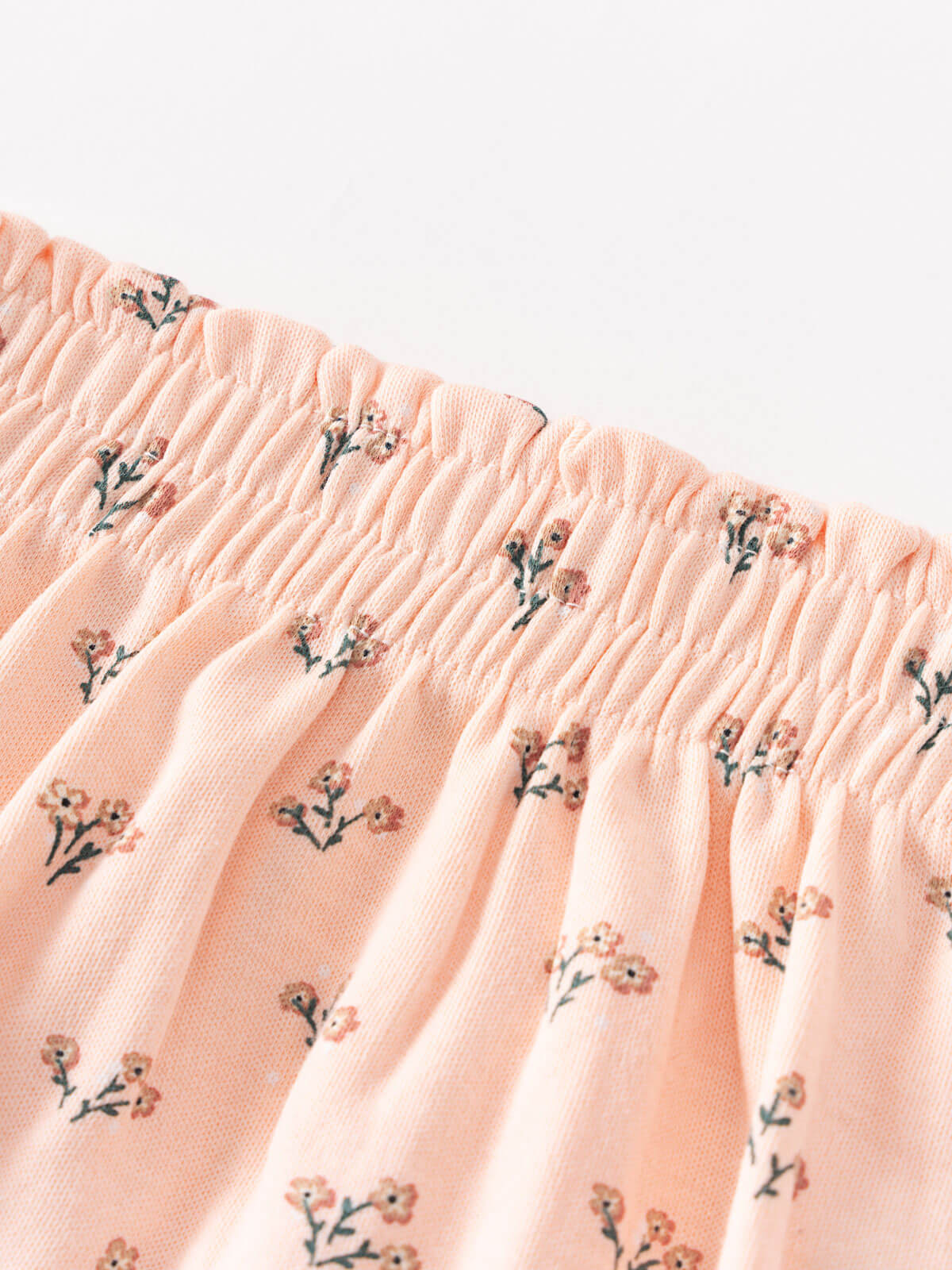 Close-up of peach fabric with floral print and gathered elastic waistband Printed Bloomers - Wildflower Bouquet Pink Baby girl