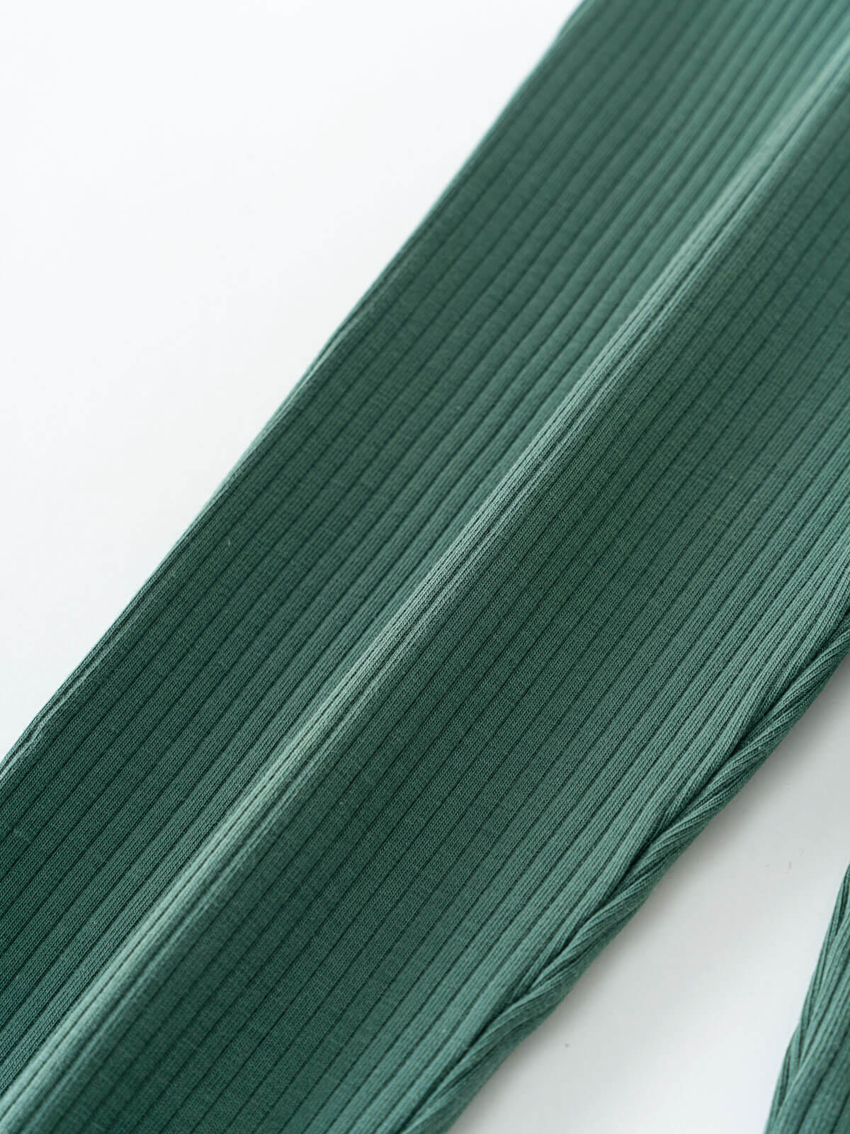 Close-up of ribbed green fabric with vertical texture and folds Ribbed Leggings - Balsam Girls