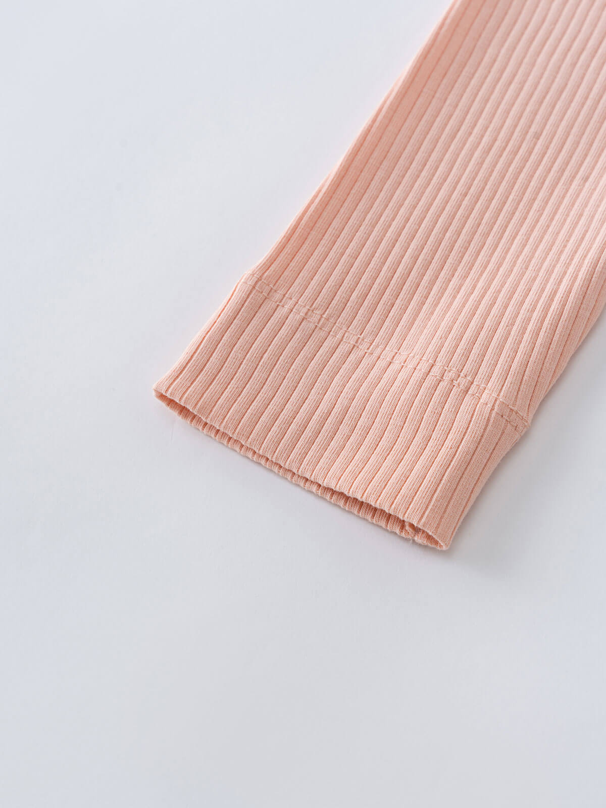 Close-up of peach ribbed fabric cuff against a light background Ribbed Leggings - Mallow Girls