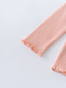 Close-up of ribbed fabric sleeves with ruffled edges in peach color Ribbed Long Sleeve Tee - Mallow Girls