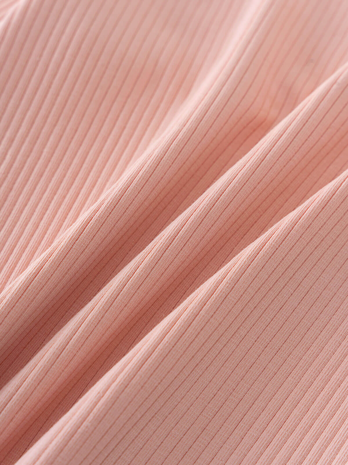 Close-up of pink ribbed fabric showing diagonal texture and fine lines Ribbed Long Sleeve Tee - Mallow Girls