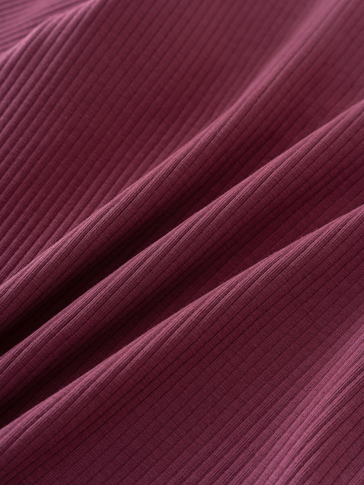 Close-up of ribbed plum-colored fabric with vertical texture and folds Ribbed Long Sleeve Tee - Plum Jam Girls