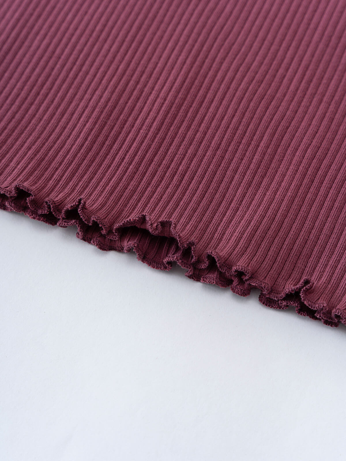 Close-up of ribbed plum fabric with decorative ruffled edge trim Ribbed Long Sleeve Tee - Plum Jam Girls