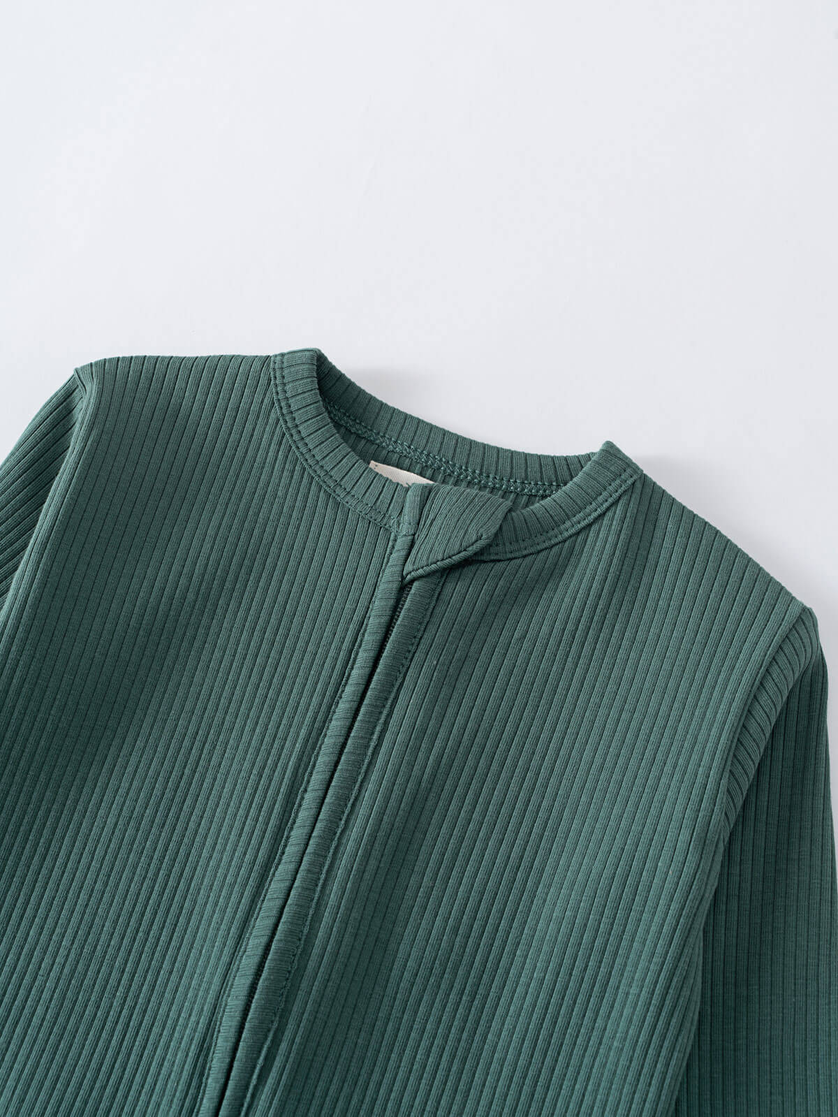 Close-up of a teal ribbed fabric garment showing neckline and shoulder detail Ribbed Long Sleeve One Piece - Balsam Baby boy