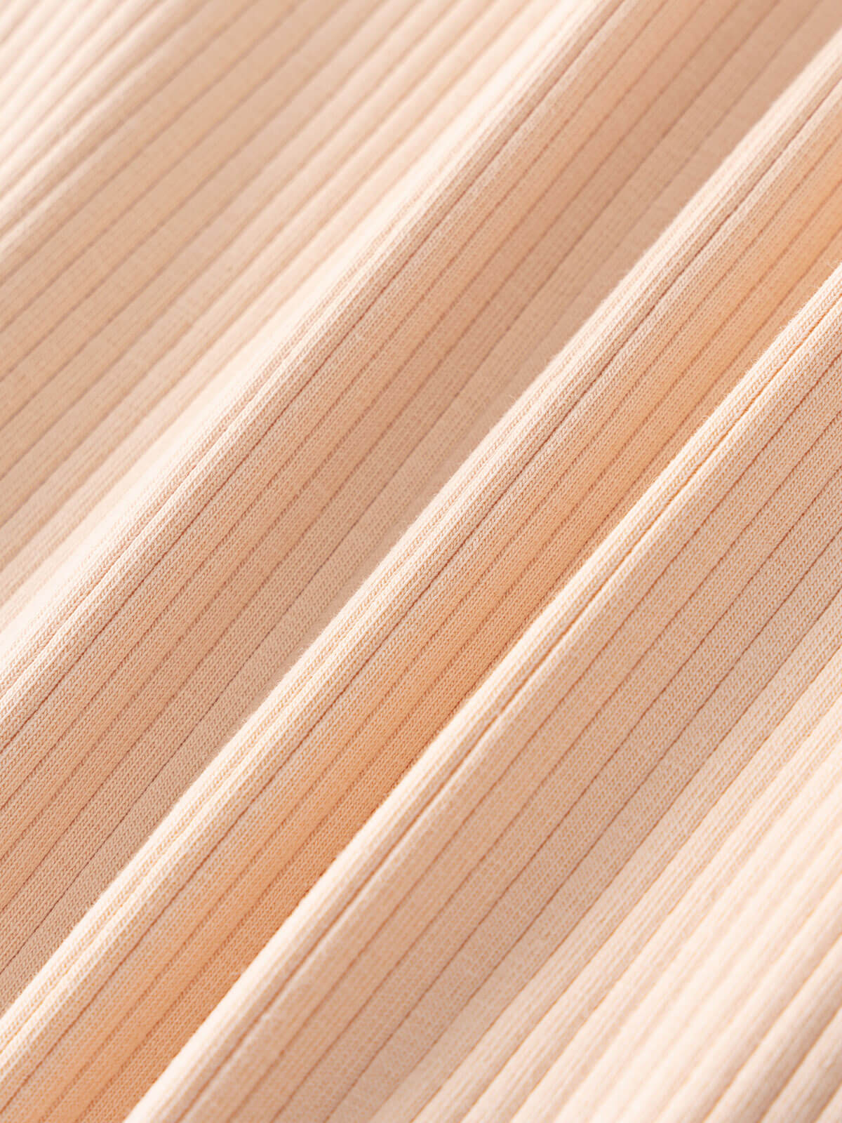 Close-up of ribbed fabric texture in warm beige and clay tones Ribbed Long Sleeve One Piece - Clay Baby girl