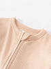 Close-up of a beige ribbed knit garment with button placket detail Ribbed Long Sleeve One Piece - Clay Baby girl