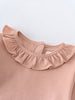 Close-up of a peach-colored bodysuit with ruffled collar and snap closure Ruffle Long Sleeve Bodysuit - Blush Baby girl