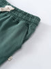 Close-up of green sweatpants showing elastic waistband and cream drawstring Sweatpants - Balsam Boys