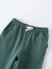 Close-up of green sweatpants with elastic waistband and cream drawstring Sweatpants - Balsam Boys