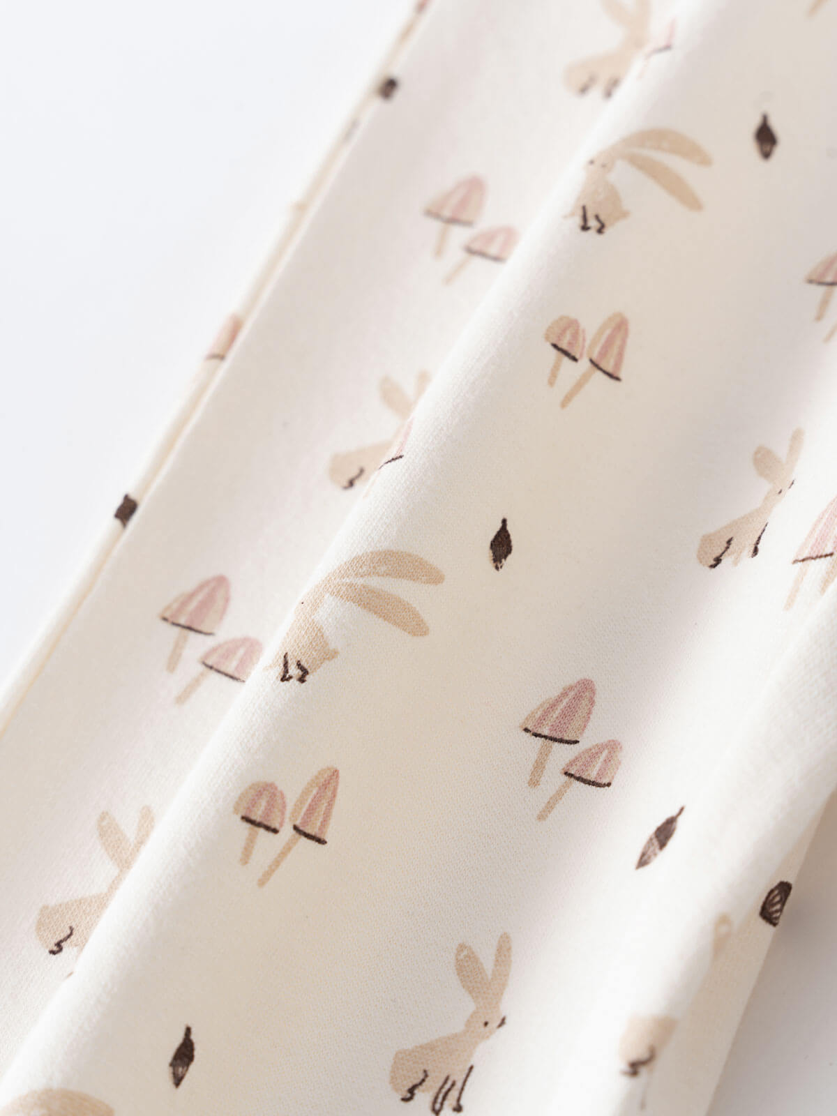 Close-up of cream fabric with mushroom and bunny print pattern Sweatpants - Forest Gathering Ecru Girls