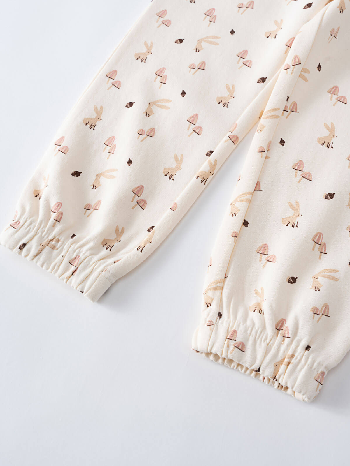 Close-up of cream fabric with small bunny and mushroom print pattern Sweatpants - Forest Gathering Ecru Girls