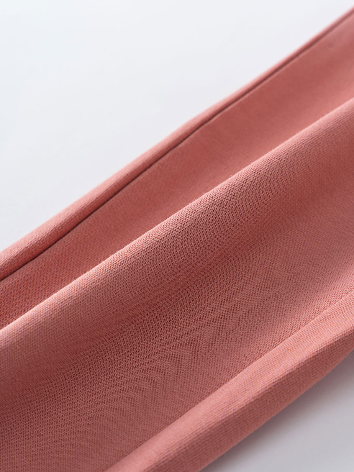 Close-up of a pink fabric texture on a white background Sweatpants - Rosehip Girls