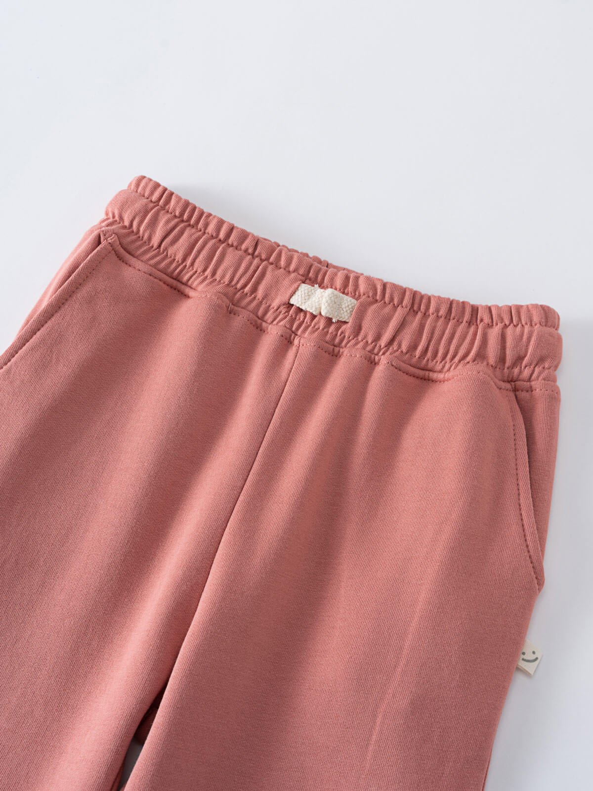 Pink sweatpants with a brand label on a white background Sweatpants - Rosehip Girls