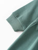 Close-up of sage green knit fabric showing ribbed cuff detail Sweatshirt Dress - Dove Girls