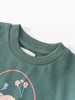 Close-up of sage green sweatshirt with floral design and ribbed neckline Sweatshirt Dress - Dove Girls