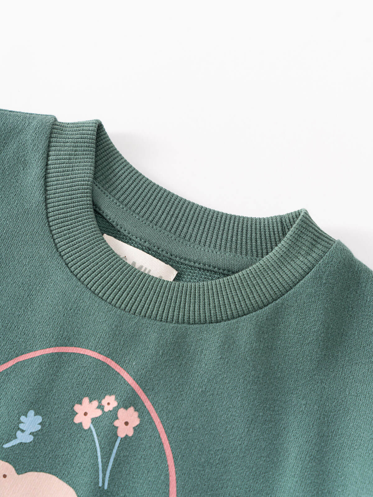 Close-up of sage green sweatshirt with floral design and ribbed neckline Sweatshirt Dress - Dove Girls