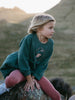 Child sitting on a rock wearing a green sweatshirt and pink leggings outdoors Sweatshirt Dress - Dove Girls