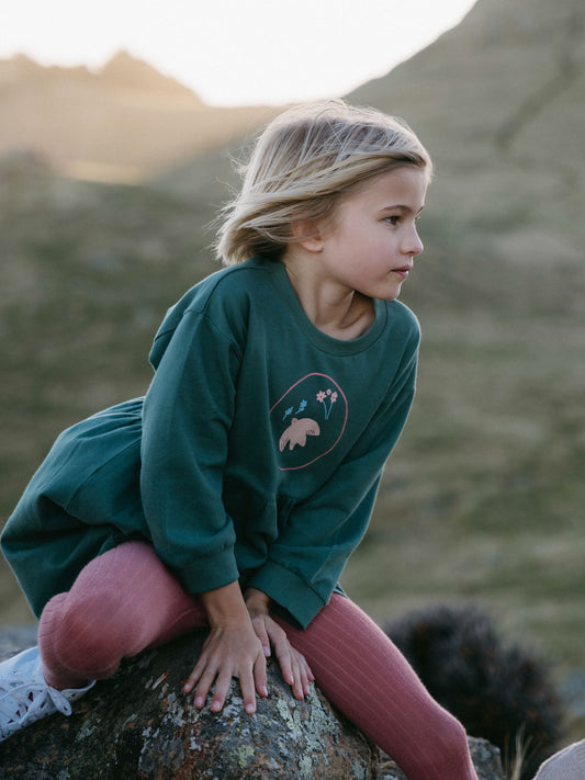 Child sitting on a rock wearing a green sweatshirt and pink leggings outdoors Sweatshirt Dress - Dove Girls