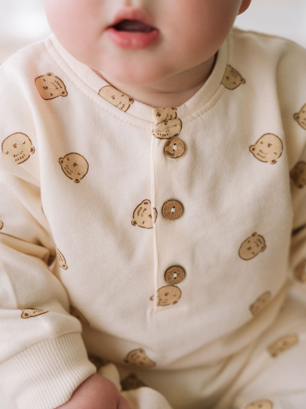 Baby wearing cream onesie with bear print and wooden buttons Sweatshirt Onesie - Cosy Bear Ecru Baby boy