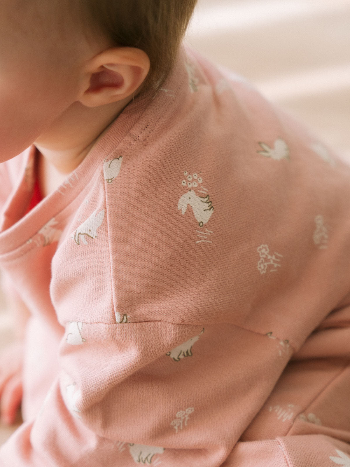 Child wearing pink sweatshirt onesie with small animal print pattern Sweatshirt Onesie - Meadow Friends Blush Baby girl