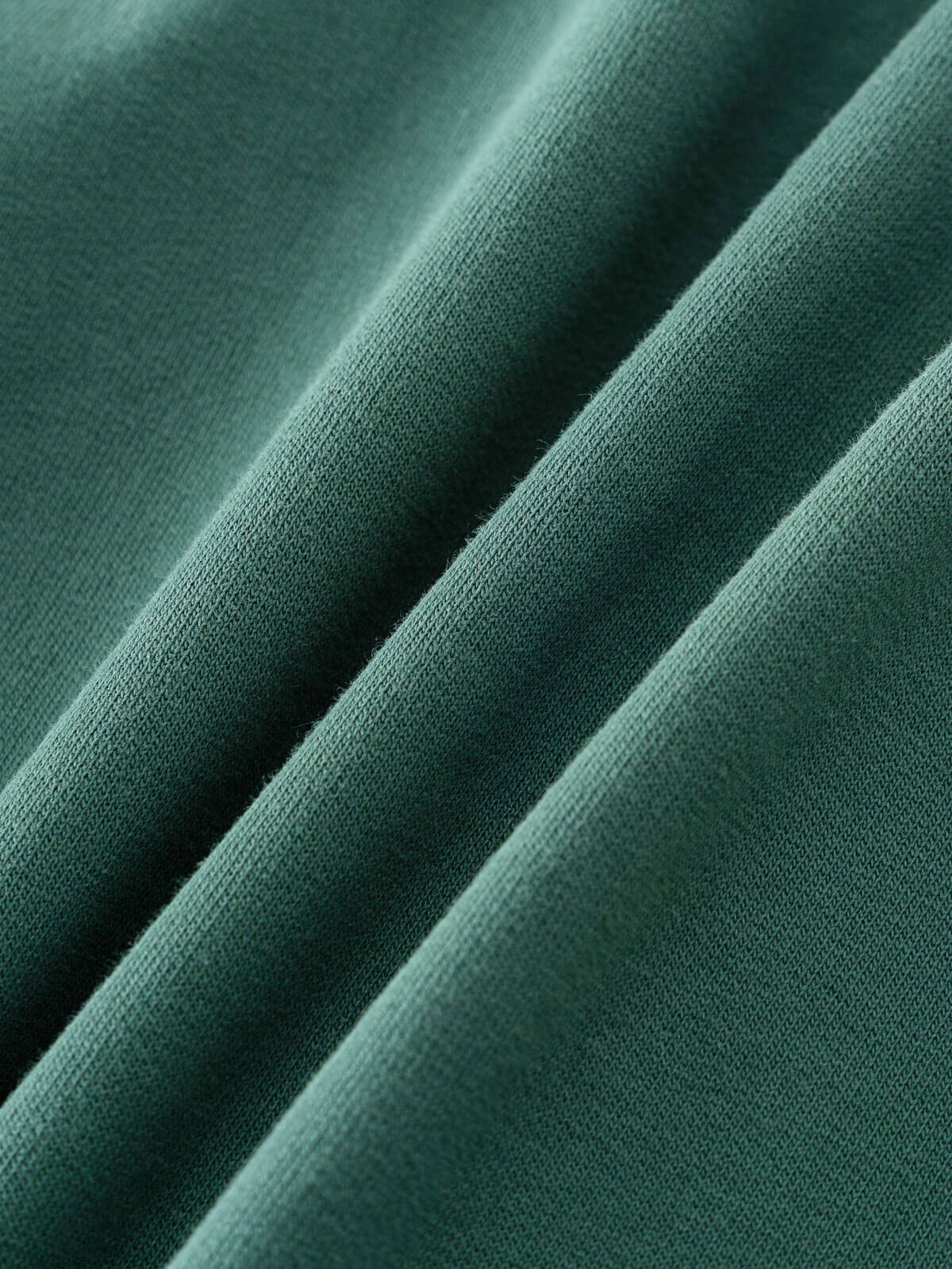 Close-up of teal green fabric with soft folds and visible texture Zip Hoodie - Balsam Boys