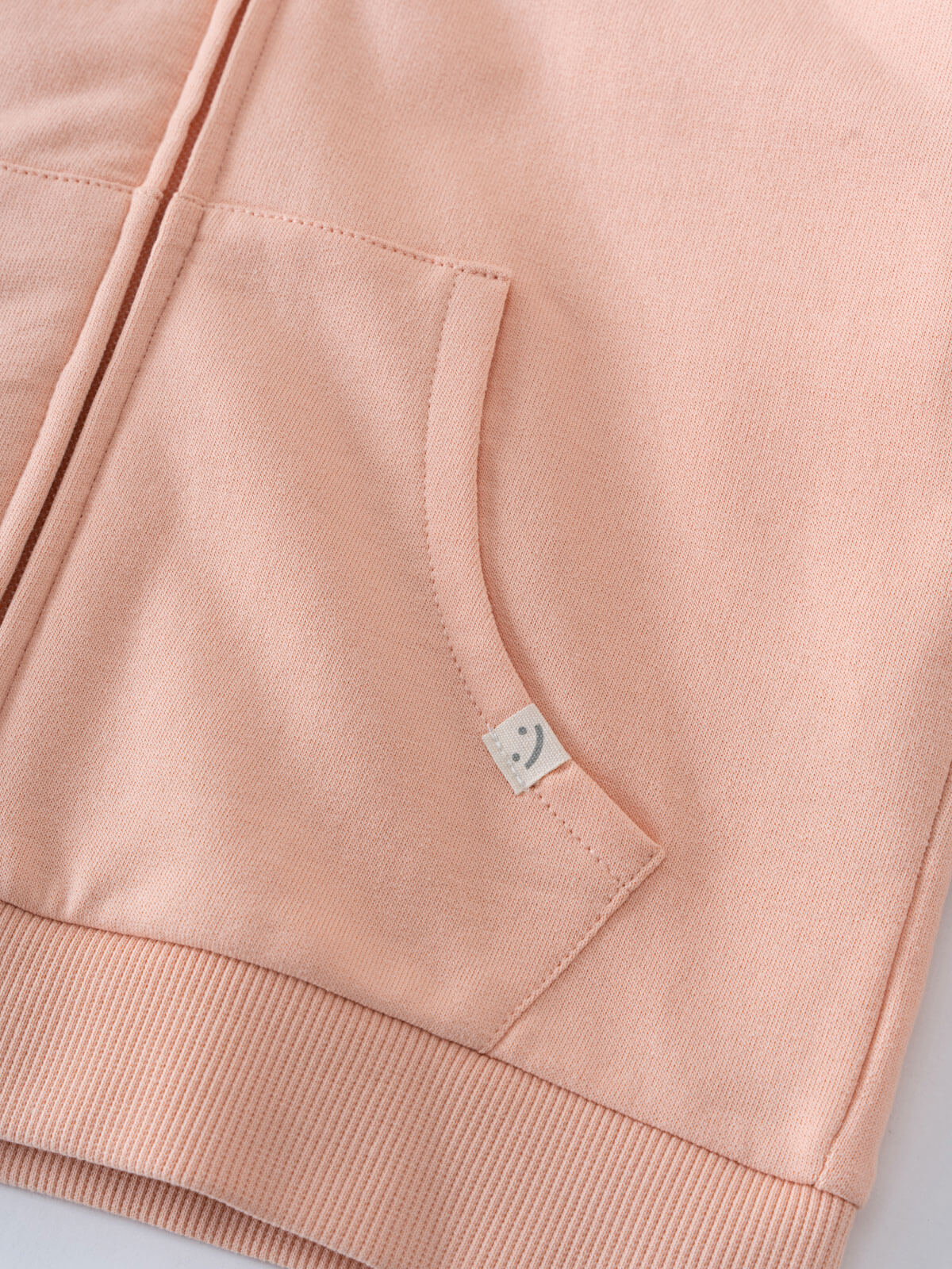 Close-up of a pink hoodie pocket with small label detail Zip Hoodie - Mallow Boys