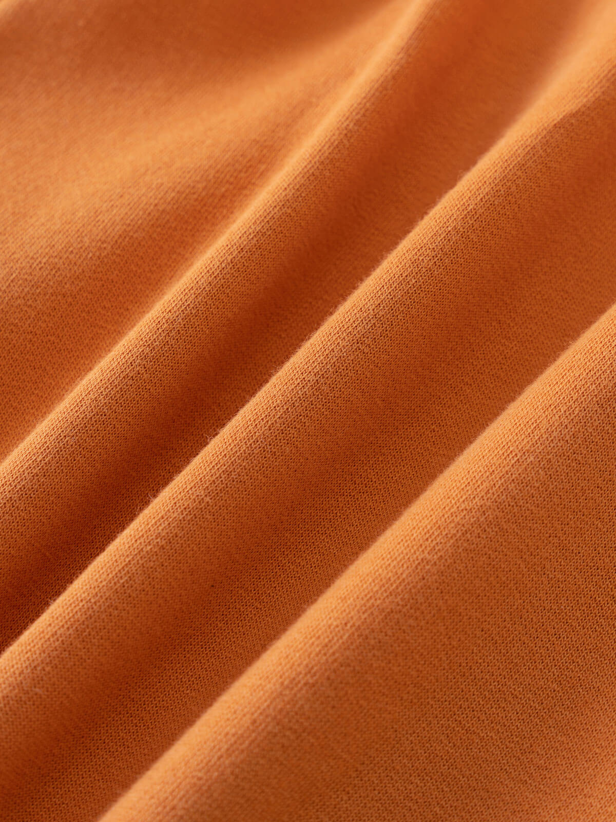 Close-up of orange fabric with visible textile weave and diagonal folds Zip Hoodie - Pumpkin Boys