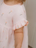Child wearing a light pink dress with floral embroidery on a neutral background Amara Dress - Poppy Field Girls