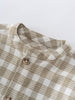 Close-up of a plaid shirt with a button on a white background Baby Check Shirt - Woven Check Baby boy