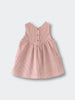 Pink corduroy dress on a light gray background