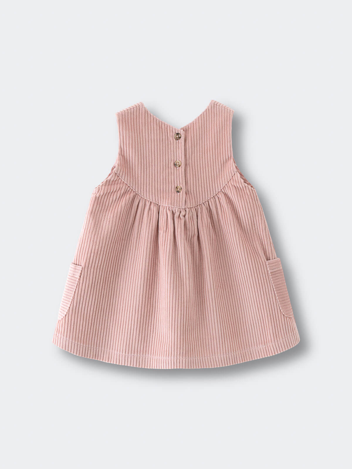 Pink corduroy dress on a light gray background