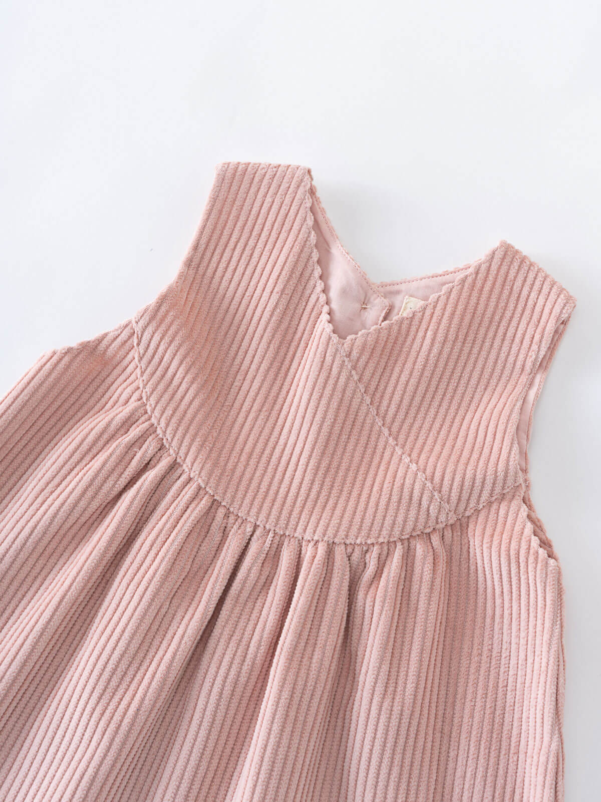 Pink corduroy dress on a white background
