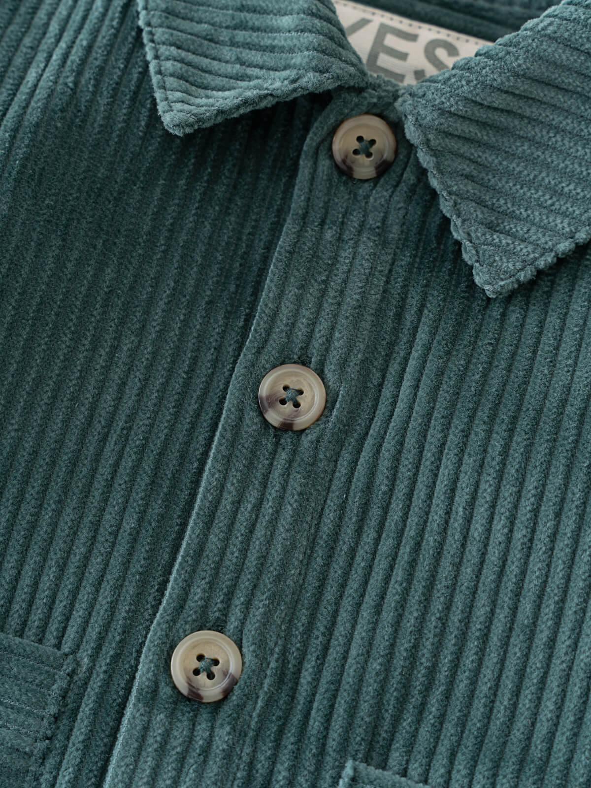Close-up of a green corduroy jacket with buttons and collar details. Baby Corduroy Jacket - Balsam Baby boy