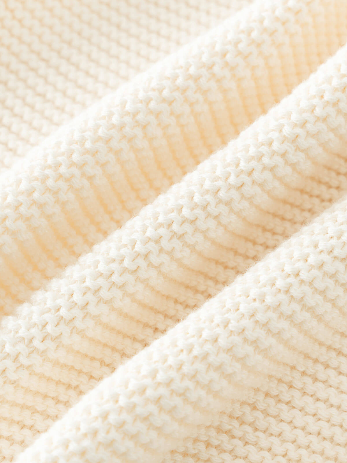 Close-up of beige knitted cotton fabric texture