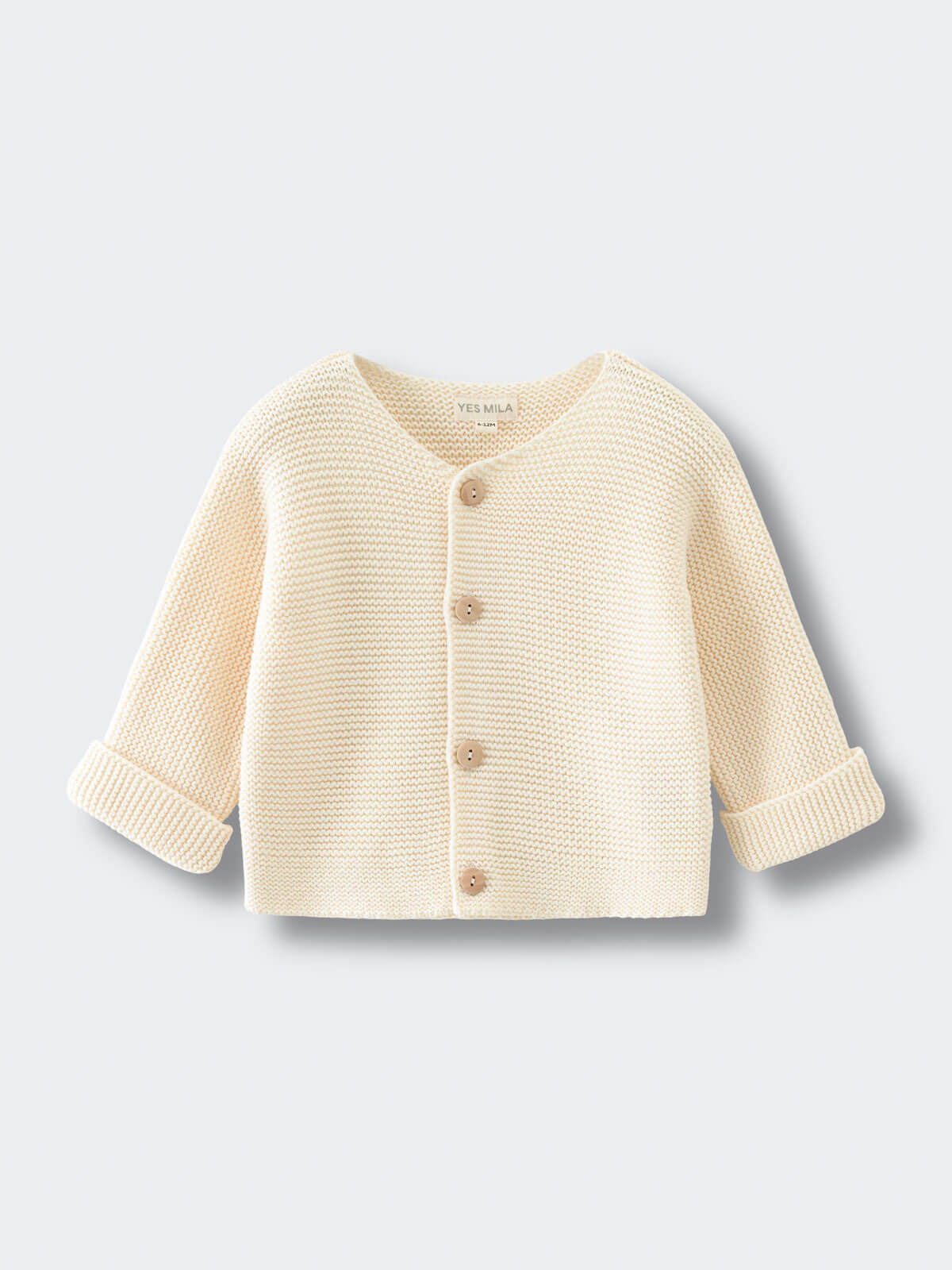 Beige baby knitted cotton cardigan on a light gray background