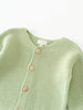 Green knitted cotton cardigan with buttons on a white background