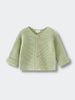 Green baby knitted cotton cardigan on a light gray background